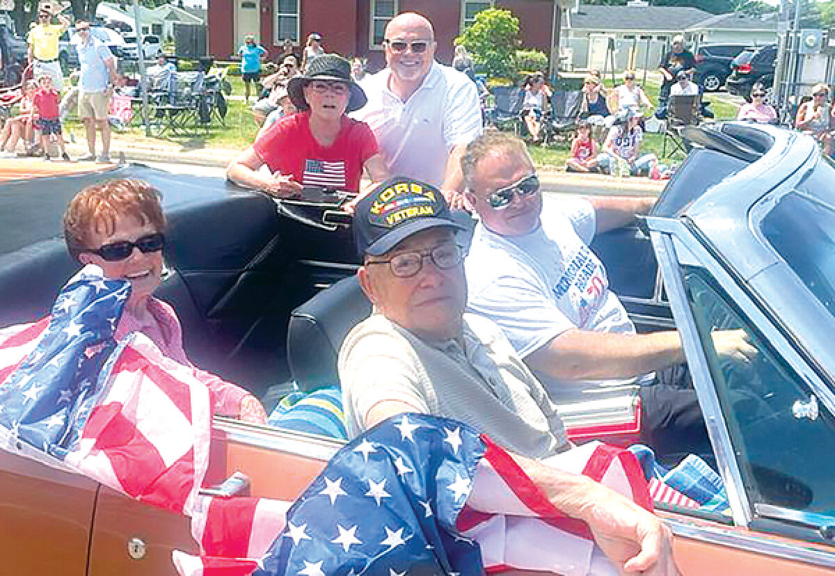  John Agnello, seen sitting in the passenger seat, was the 2023 St. Clair Shores Veteran of the Year during last year’s St. Clair Shores Memorial Day Parade. Also pictured are, from left, his wife Mary Lou Agnello; his daughter Kathy Agnello Hanson; his son Michael Agnello; and Councilman Chris Vitale. 