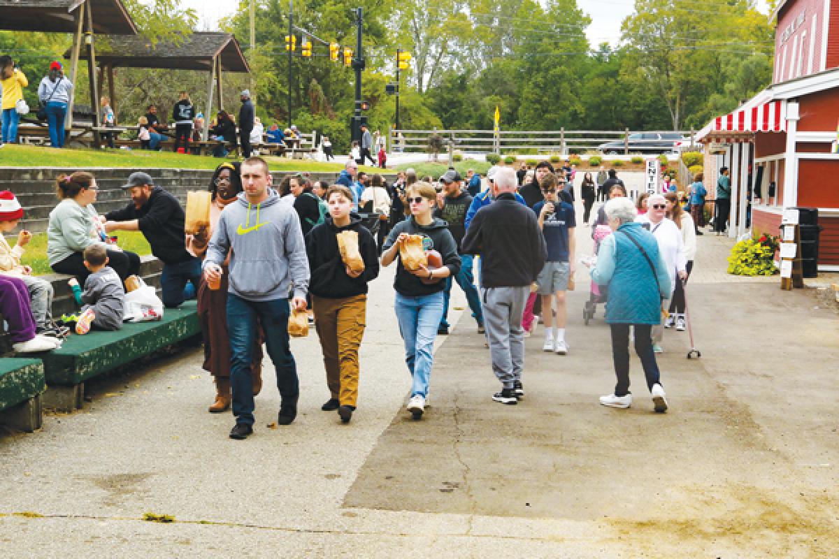  Families and friends enjoy some sweet treats at Yates Cider Mill in Rochester Sept. 7.  