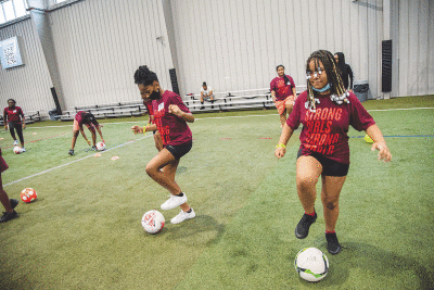 A group of ladies participate in soccer drills during the event. 