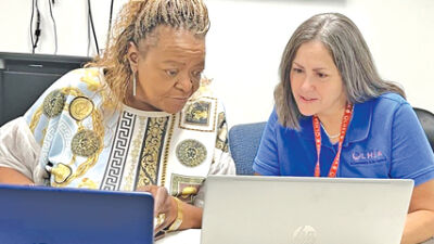  Lesa Tripp, of Southfield, left, and OLHSA Grandparents Raising Grandchildren Program Operations Manager Lisa Grodsky, right, attend the “Gigabytes for Grand-families.”  