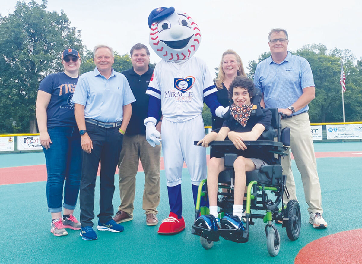  From the left, Amanda Gebhardt, Ben Mondloch, Brent Wirth, Homer the Brave — the Miracle League Mascot, Kendra Davenport, Zander Schons and Jason Slocum attend the Books, Breakfast and Baseball event Aug. 27 at the Easterseals MORC Miracle League Field in Southfield. 