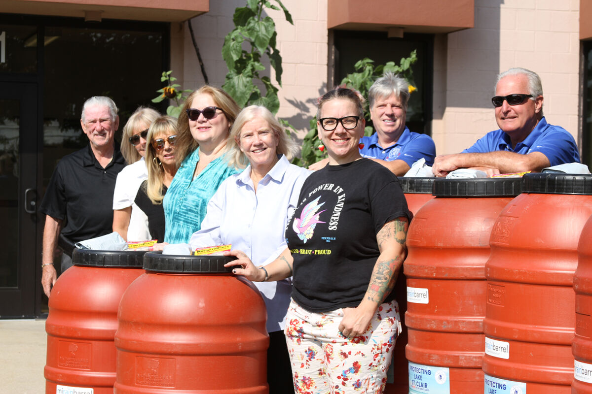  Members of the Roseville City Council and Department of Public Services pose for a picture with residents Dawn Bielawski, fourth from left, and Samantha Russell, third from right. In between Bielawski and Russell is Macomb County Public Works Commissioner Candice Miller, whose department headed up the program. 