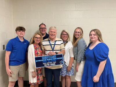  Mel Blohm, a Reuther Hall of Fame inductee, stands with his family and holds his plaque. 