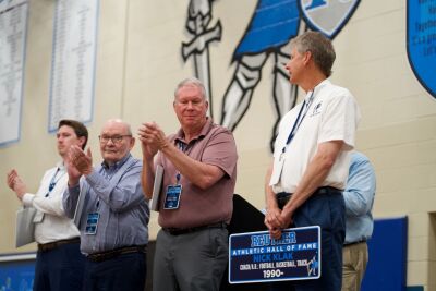  Nick Klak, who orchestrated the Hall of Fame event and has been at the school since the 1988-1989 school year, is all smiles after receiving his plaque to a standing ovation from the crowd. 