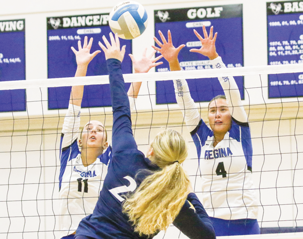   Warren Regina junior Lilly Zdankiewicz and senior Calista Mastry go for the block against a Royal Oak Shrine Catholic player. 