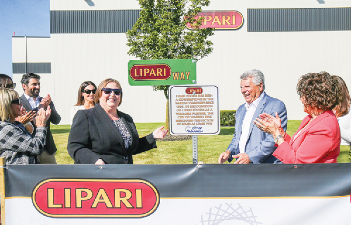  Mayor Lori Stone unveils the Lipari Way signage and issues a proclamation to the delight  of Thom Lipari, recently retired CEO of  Lipari Foods, his family and employees. 