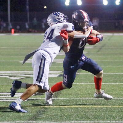  Sterling Heights Stevenson senior Graham James is tackled by Macomb Dakota senior Jacob Bajis. 