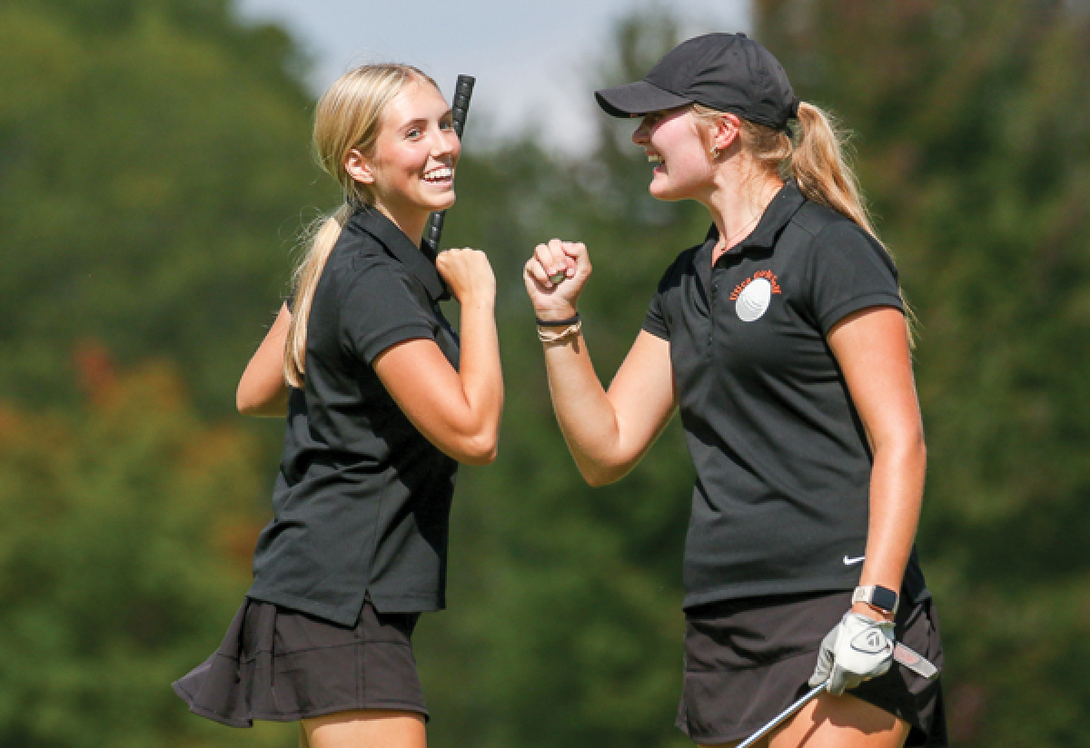   Utica juniors Cali Kaczmar, left, and Riley Burton celebrate a strong start during their matchup against St. Clair on Sept. 18 at Stony Creek Metropark Golf Course. 