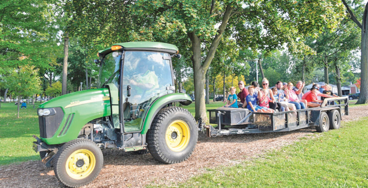  Attendees at the 2023 Clawson Fall Festival take a hayride with the help of a tractor. 