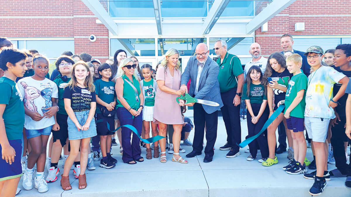  Novi Meadows Principals Lisa Fenchel and John Brickey smile as they cut the ribbon to symbolize the opening of the new school Sept. 16. 