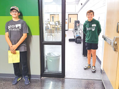  Sixth graders Ian Leggett, 11, and Cason Kliebert, 12, welcome guests into their band classroom during the school’s community open house Sept. 16. 