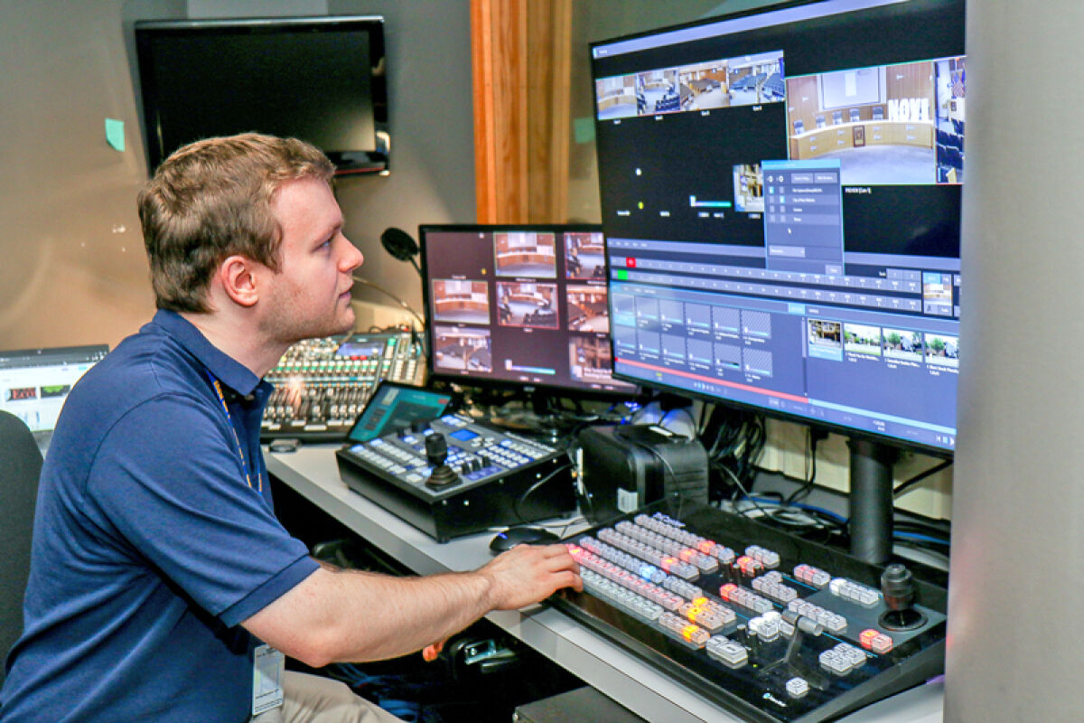  Jason Nunez demonstrates how he operates the switcher in the control room when filming a Novi City Council meeting. 