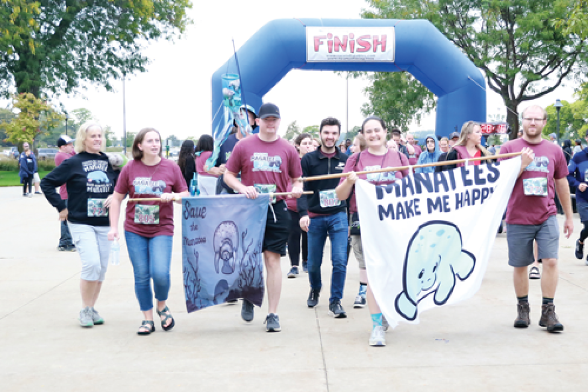  The Maneke Family from Indiana and New Jersey crosses the finish line at the 21st edition of the Save the Manatees 5K at Lake St. Clair Metropark on Sept. 28. 