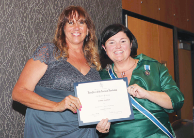  Debbie McClain, left, of Warren, president of the Prisoner of War Committee of Michigan, received the Daughters of the American Revolution of Michigan’s community service award from DAR State Regent Dawn Brady, right. 