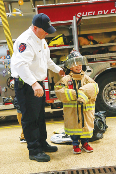  Trying on a firefighter’s turnout gear will be  another activity available at the Shelby Township  Fire Department’s open house Oct. 12. 