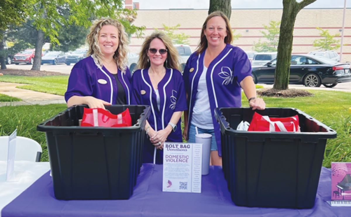  From left, the Butterfly Collective’s executive team of Ashley Sonnenfield, Heidi McQuade and Jennifer Kaferle collects funds at a past event to help local individuals who are survivors of domestic violence rebuild their lives. 