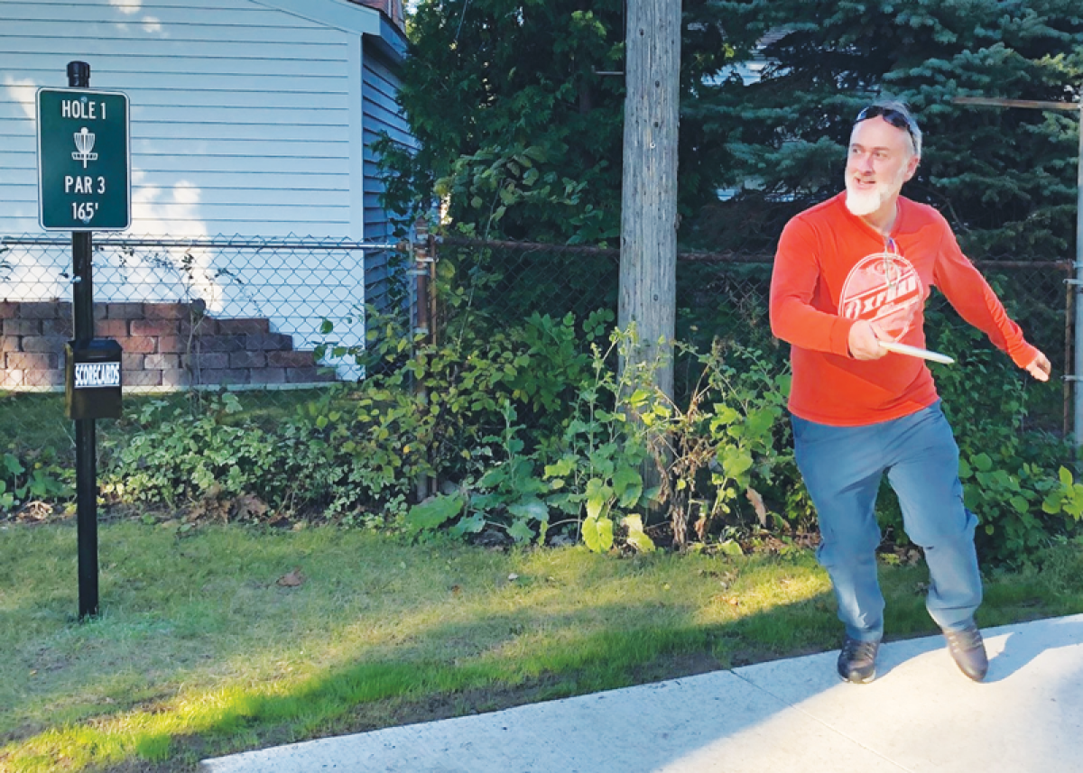  Grosse Pointe Woods resident David Bourgeois, a longtime disc golf player, demonstrates the game during a ribbon-cutting Oct. 2 at the Ahee Jewelers Disc Golf Course, which Bourgeois designed. 