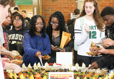  North students gather around the paella to see it and dish some out for themselves. 