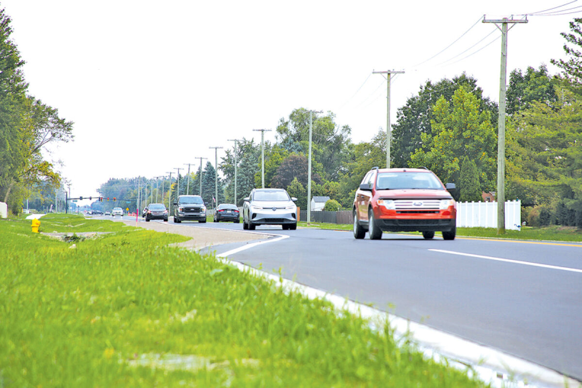  Cars drive on the newly-opened stretch of Garfield Road between 23 Mile Road and 25 Mile Road in Macomb Township.  