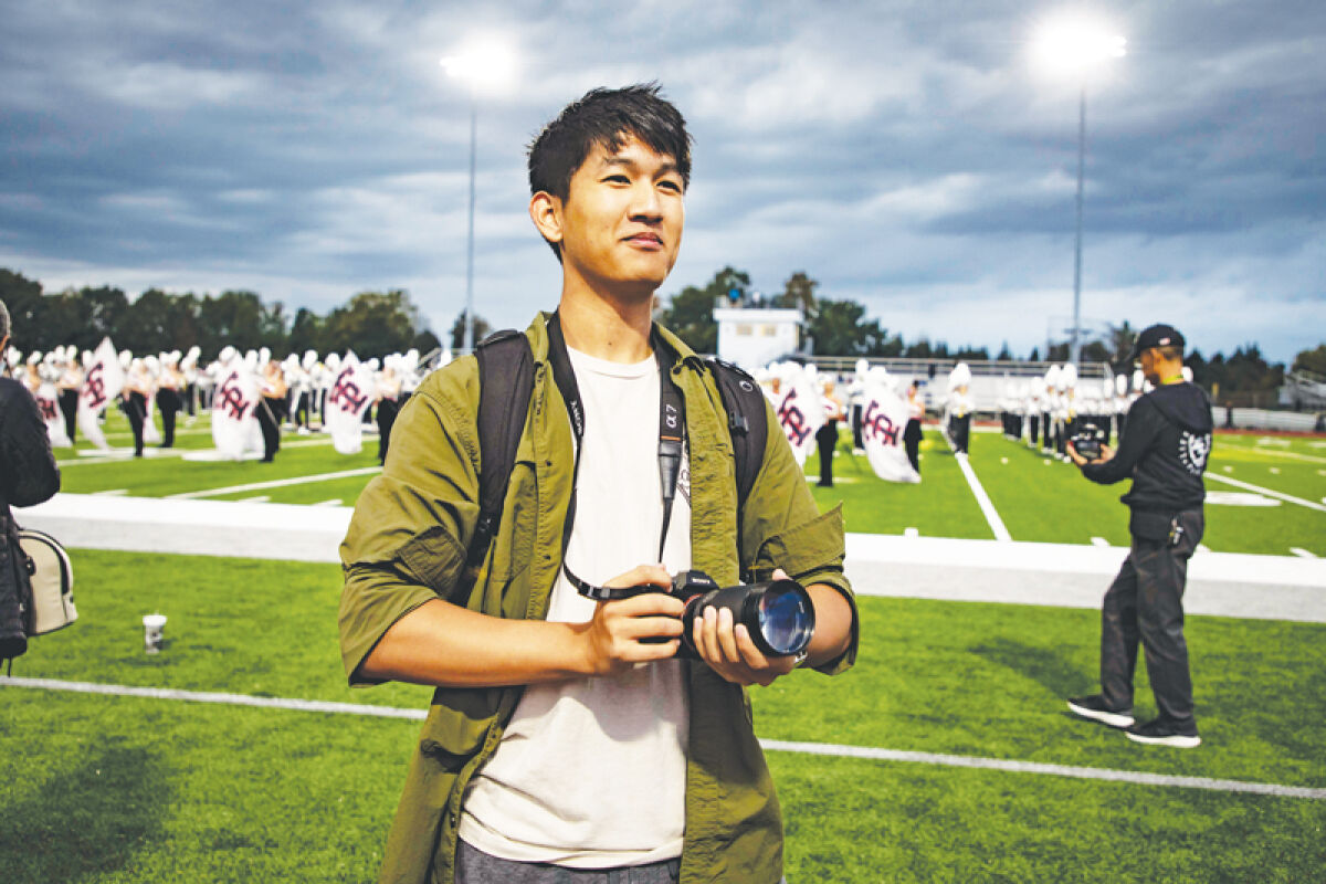  Troy High School senior Michael Zheng covers sporting events for Troy schools as a part of his work with the Creative Guild. 