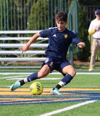  Royal Oak Shrine Catholic High School  junior Adam Imai controls the ball. 