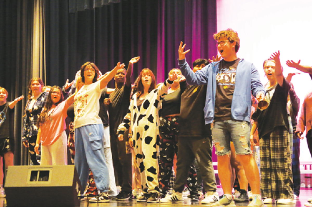  Sophomore Justin Maciejewski, wearing a blue sweatshirt, and junior Blake LaFontaine, in a gray sweatshirt, fight for attention of townsfolk as Lord Pinkleton and Jean-Michel during a pajama day-rehearsal for Chippewa Valley High School’s production of “Rodgers & Hammerstein’s Cinderella.”  