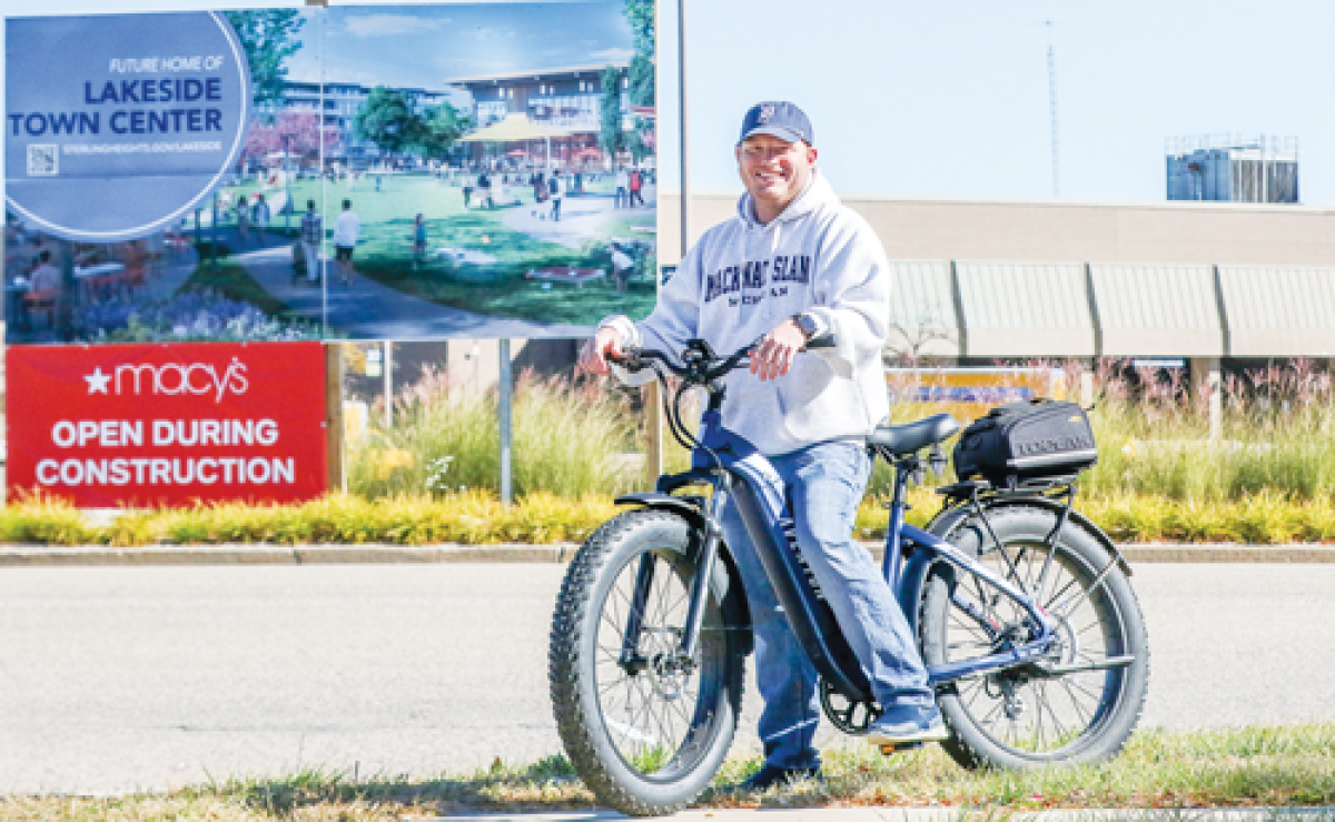  Ronnie McCabe, from Sterling Heights, is aboard his new electric bike, which he got as a result of winning a bike path naming contest for the upcoming Lakeside City Center. 