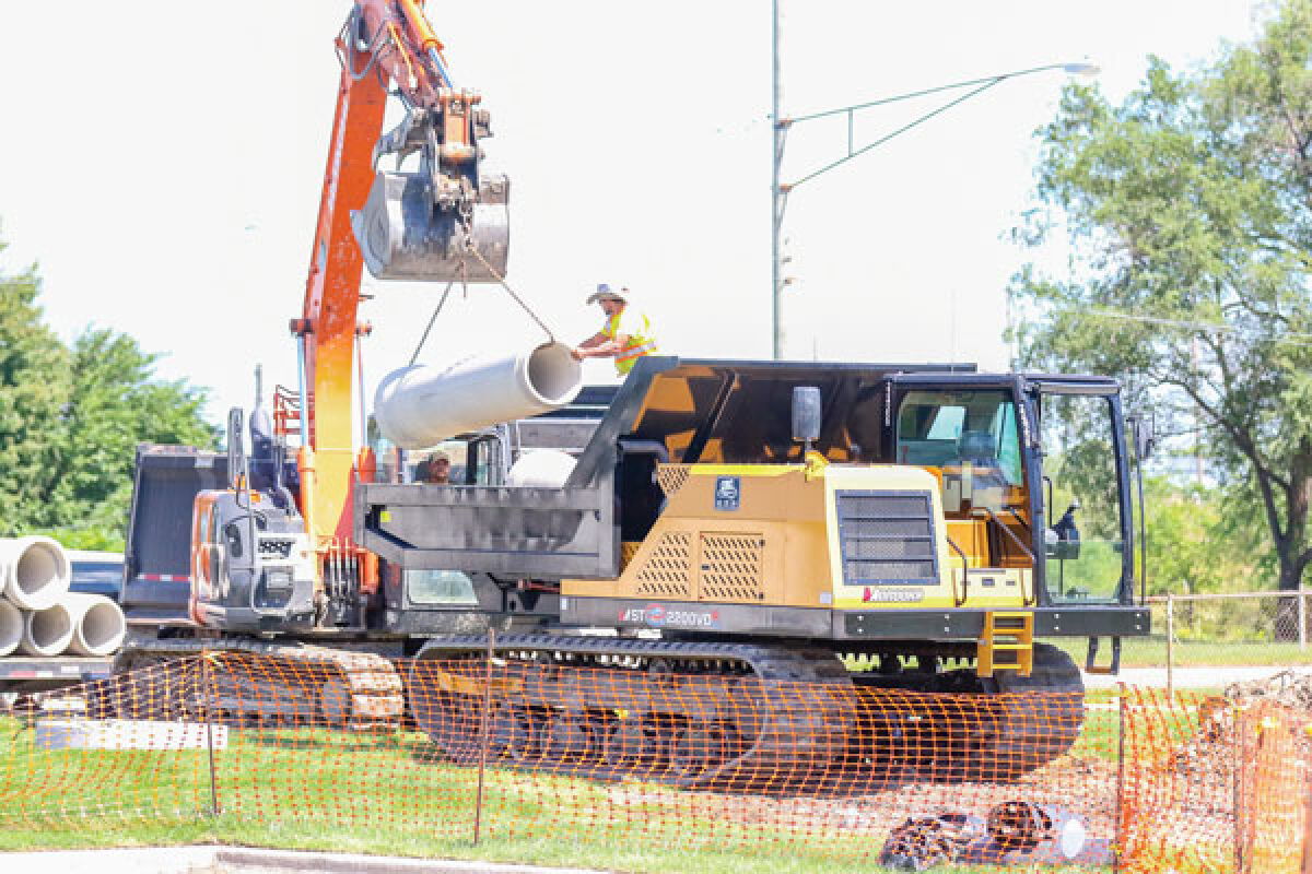  Workers load parts of the drain for delivery to the worksite in Roseville Aug. 31. 