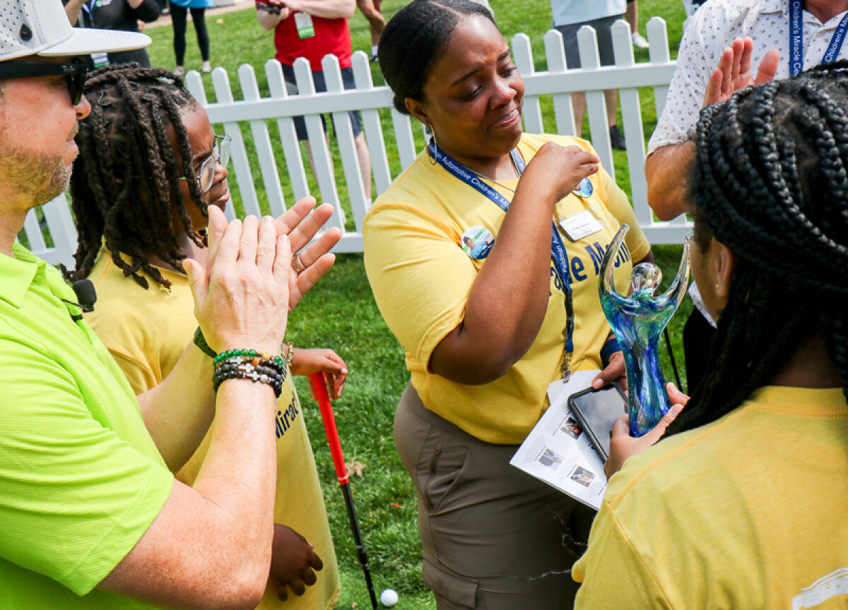  Fran Watson, of Southfield, is brought to tears as she is presented with the Alma Wahlberg award by the Wahlberg family at the Feldman Automotive Children’s Miracle Network Celebrity Invitational on Aug. 26 at the Detroit Golf Club. 