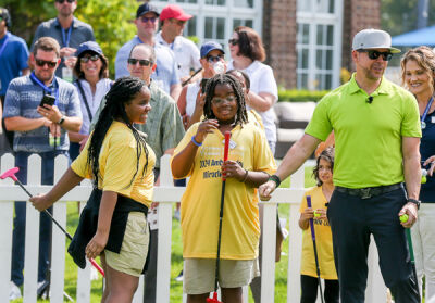  Miracle Kid Rylee Watson celebrates after beating singer/actor Donnie Wahlberg, of the New Kids on the Block, in a putting challenge. 