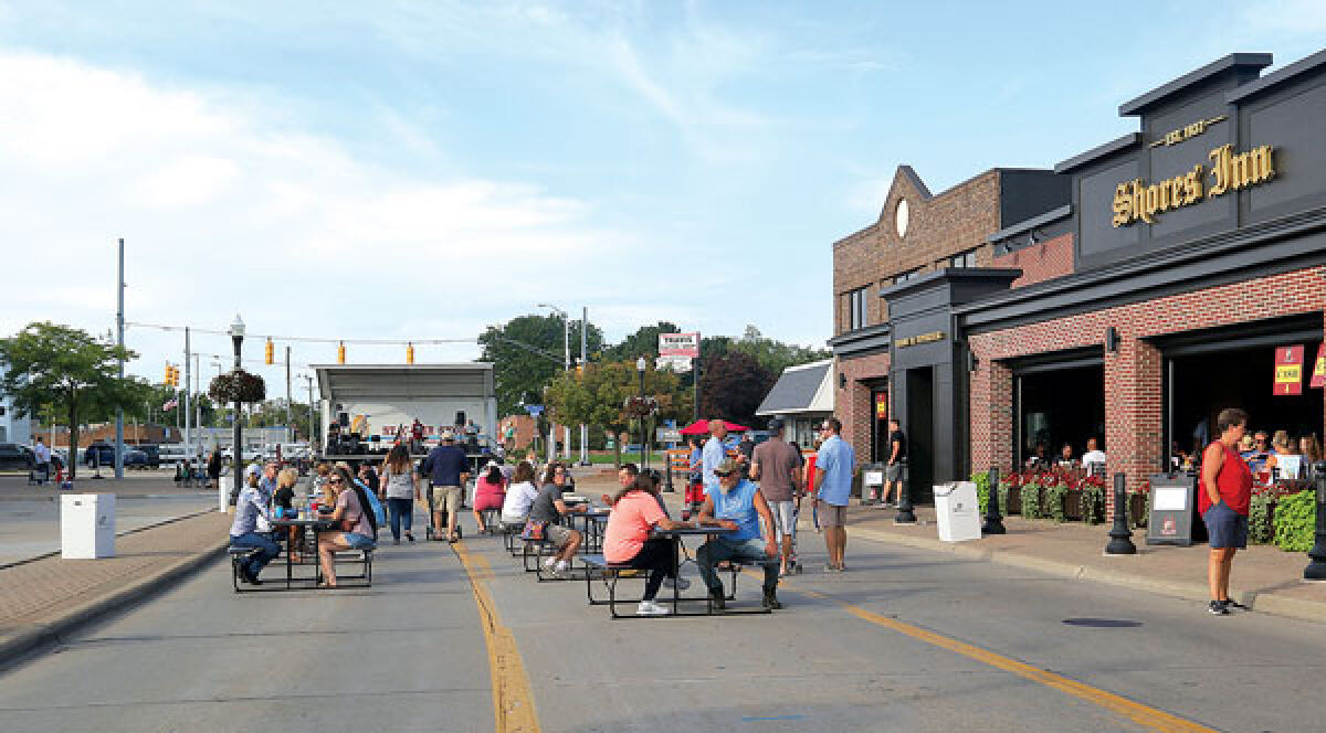  Attendees enjoy the Downtown St. Clair Shores Social District Aug. 27, where they can drink and listen to music.  