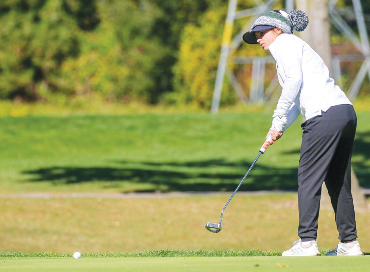  Macomb Dakota sophomore Angelina Accuso putts during regional play Oct. 9 at Fieldstone Golf Club in Auburn Hills. 