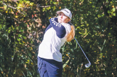  Macomb Dakota freshman Dakota Cooper follows through on her swing during regional play Oct. 9 at Fieldstone Golf Club in Auburn Hills. 