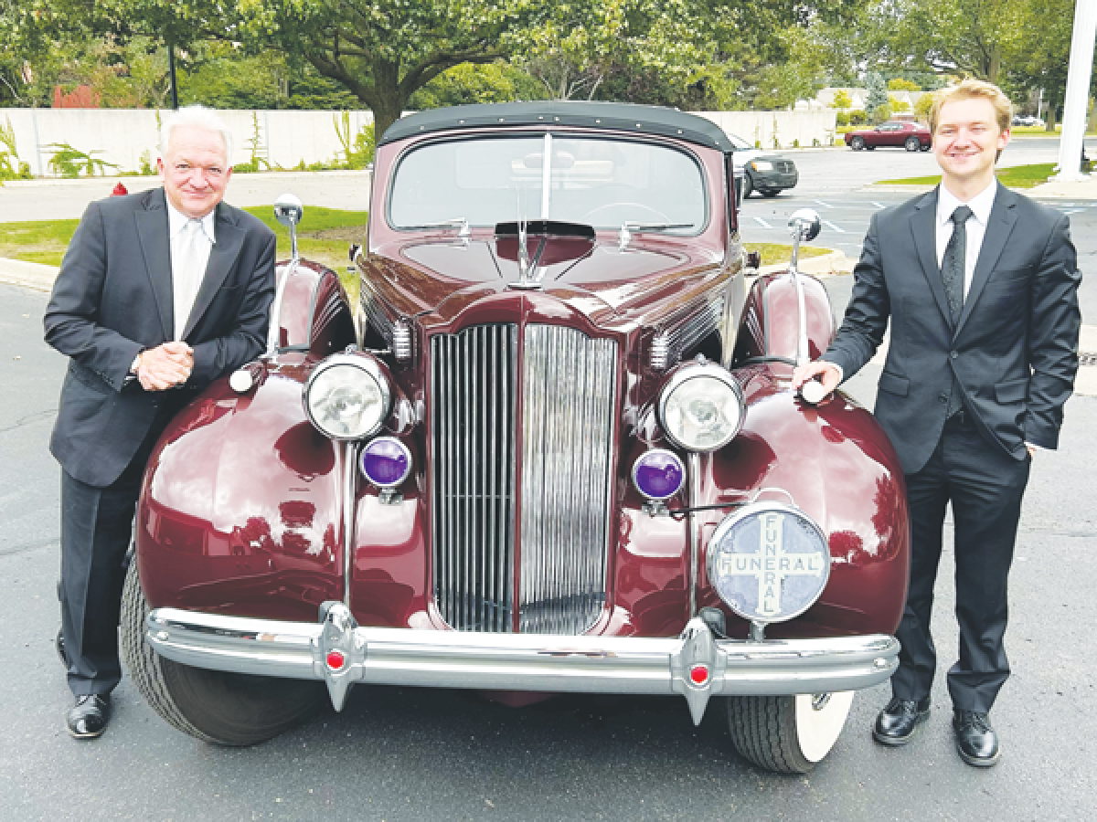  Jeff Mandziuk, owner of Mandziuk & Son Funeral Directors Inc., left, and his son, Mitchell, have continued taking care of the Packard hearse collection that Eugene Mandziuk started in the 1980s. 