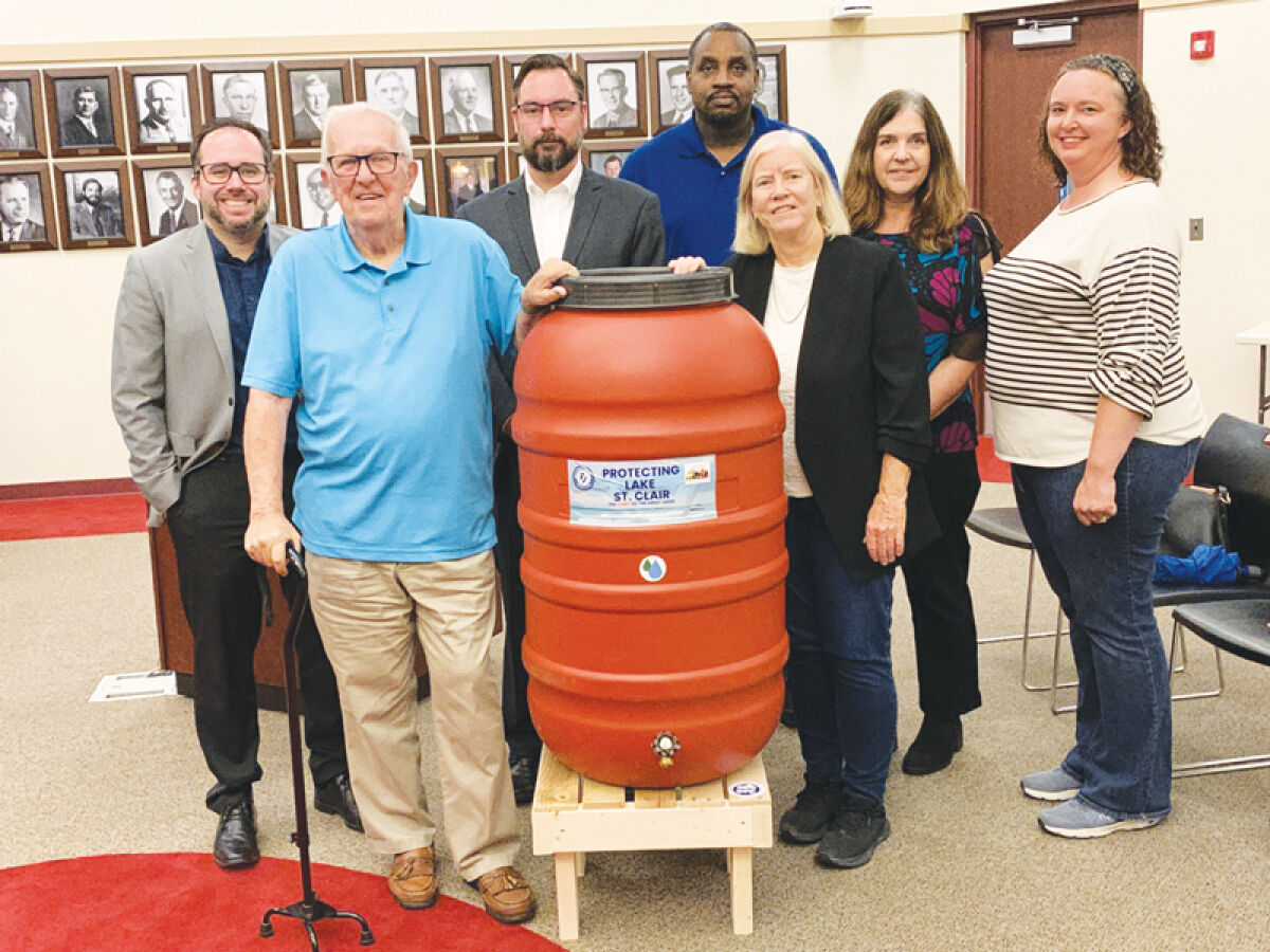  Macomb County Public Works Commissioner Candice Miller, right of center, and Macomb County Commissioner Sarah Lucido, right, pose for a photo with the members of the Eastpointe City Council and one of the rain barrels being given to the city at the Eastpointe City Council’s Oct. 1 meeting. 