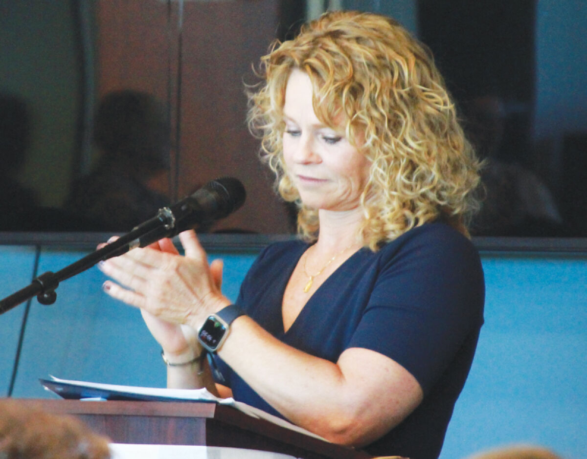  Chief Judge Carrie Lynn Fuca of the 41B District Court claps during the graduation ceremony for the Veterans Treatment Court Oct. 10. Fuca presides over the VTC. 