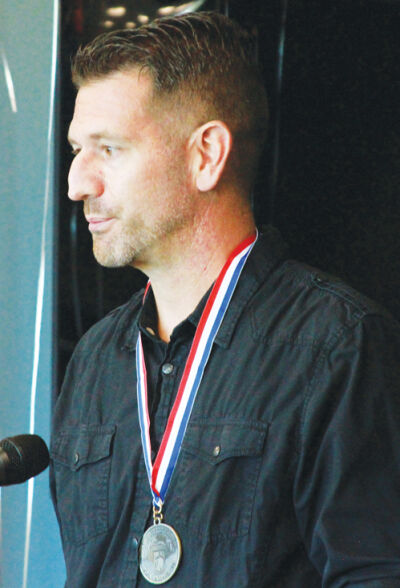  Jason Hosking, a U.S. Air Force veteran, stands at the podium. 