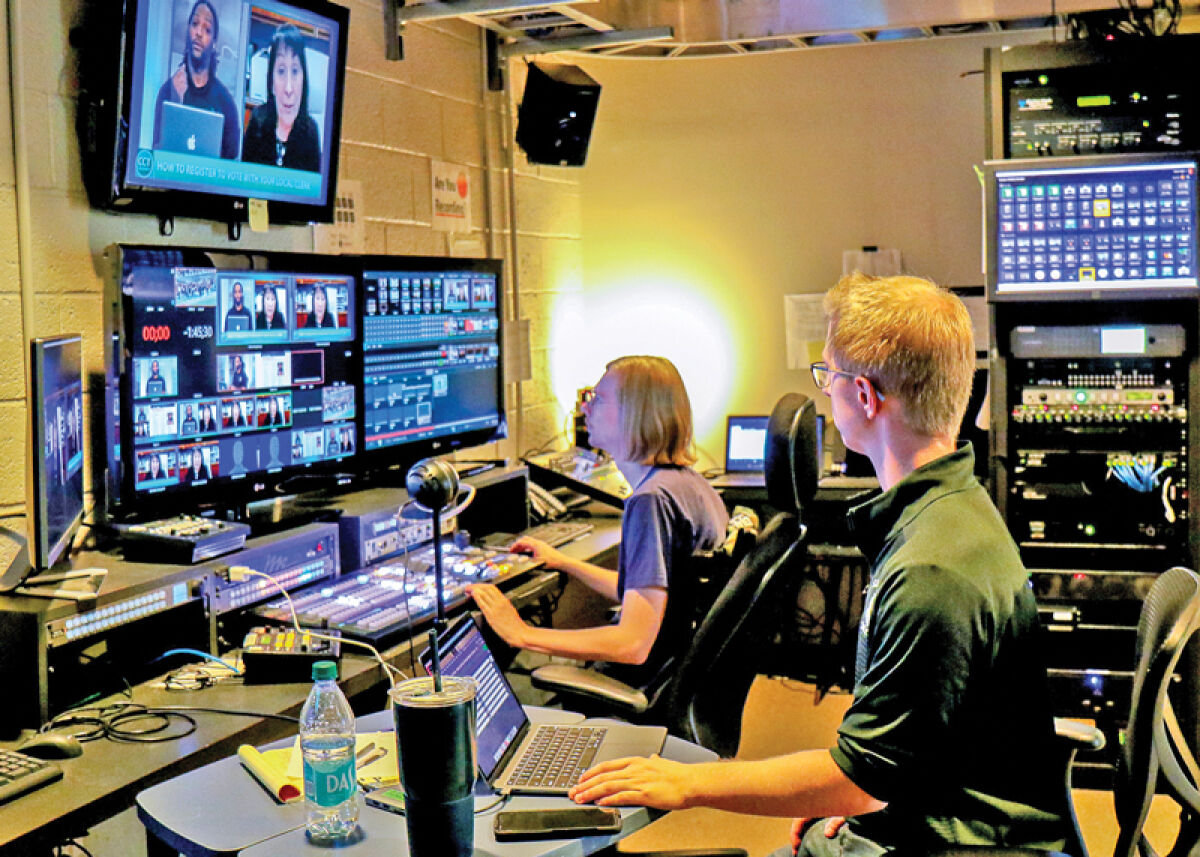  Tyler Kieft, in the foreground, and Calvin Brown work in the control room during a live broadcast on Civic Center TV. Programming for Civic Center TV includes local government meetings in the Greater West Bloomfield area. 