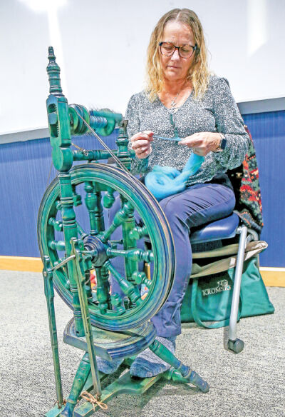  Jenn Towianski spins wool into yarn. She bought it in its raw state, carded the wool and dyed it all on her own. 