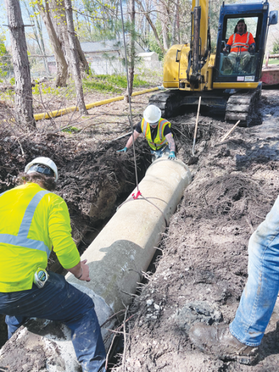  The Macomb County Department of Public Works replaces the rotted pipe with a new 18-inch-diameter concrete pipe.  