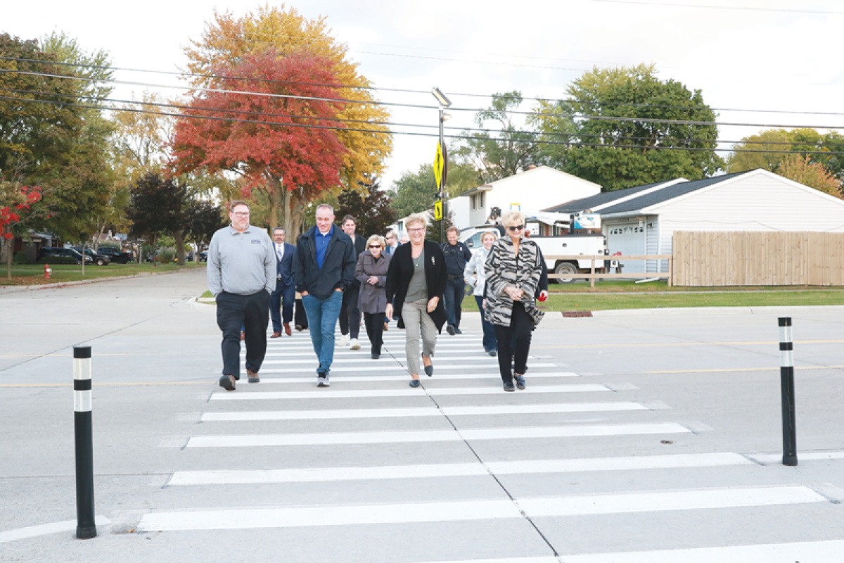   Sterling Heights city officials try out the crosswalk.  