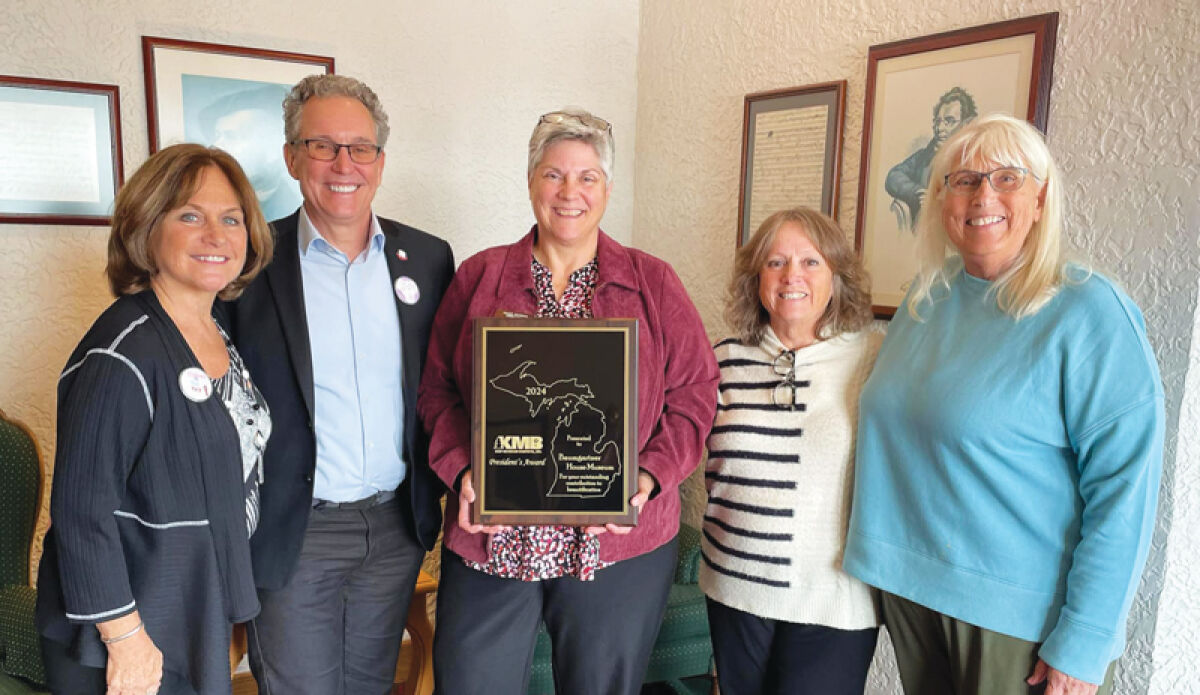  From left, Laura Lesich, Fraser Mayor Michael Lesich, Marti VanEenenaam-Iwanicki, Vania Apps and Sue Bertolini-Fox pose for a photo with the President’s Award the Baumgartner House Museum received from Keep Michigan Beautiful Inc. 