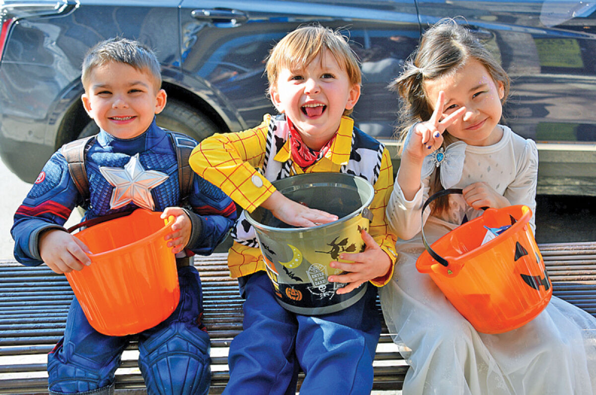  Archer England, 4, of Madison Heights; Rowen Oneill, 4, of Royal Oak; and Athena Kyro, 5, of Madison Heights, enjoy the 41st annual Spooktacular in downtown Royal Oak. 