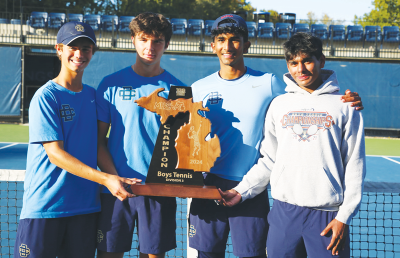  Detroit Country Day celebrates a MHSAA Division 3 state championship win, tying Ann Arbor Greenhills for the top spot Oct. 19 at Cranbrook Kingswood High School. Pictured, from the left, are Thomas Bresson, Dan Marin, Achyut Reddy and Saahith Reddy. 