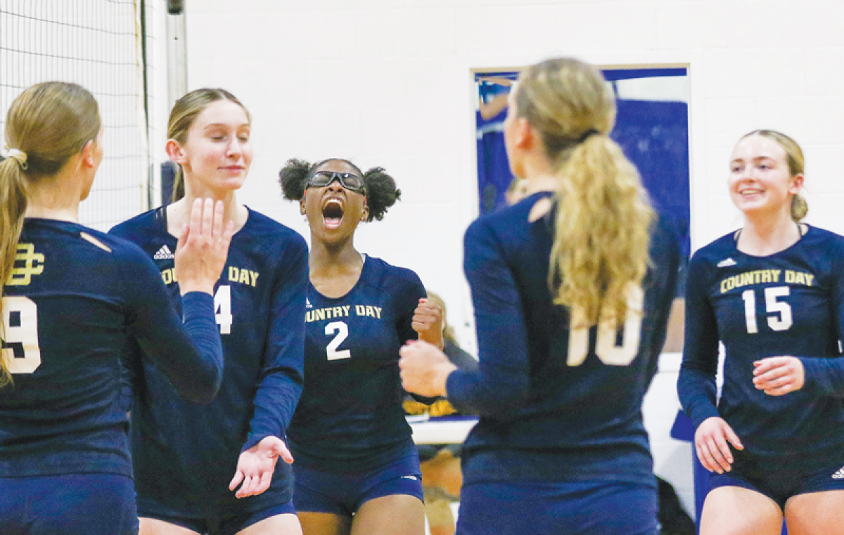  Country Day, especially sophomore Demi McCoy (#2), gets fired up after a point in a matchup against Hartland High School Oct. 24 at Country Day High School. 