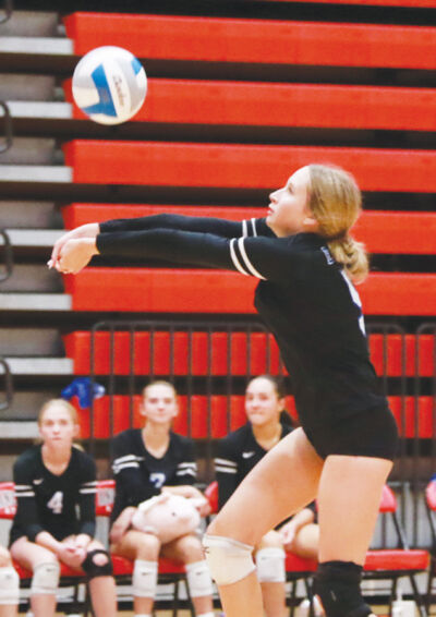  Utica Eisenhower sophomore Elise Biermann digs the ball. 