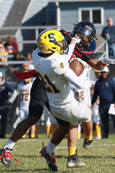  Warren Michigan Collegiate junior Patrick Baker lays a big hit on a Royal Oak Shrine Catholic ball carrier. 