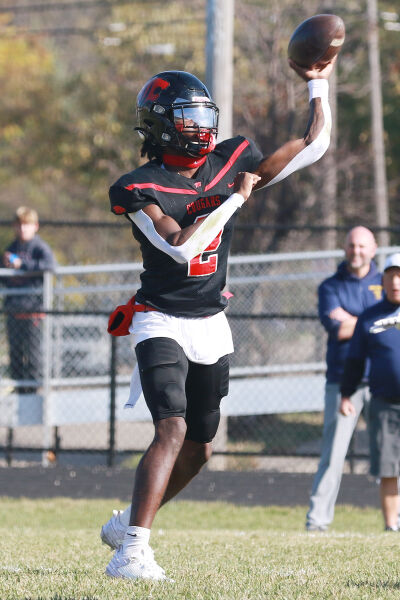  Warren Michigan Collegiate senior Caleb Moore delivers the ball 