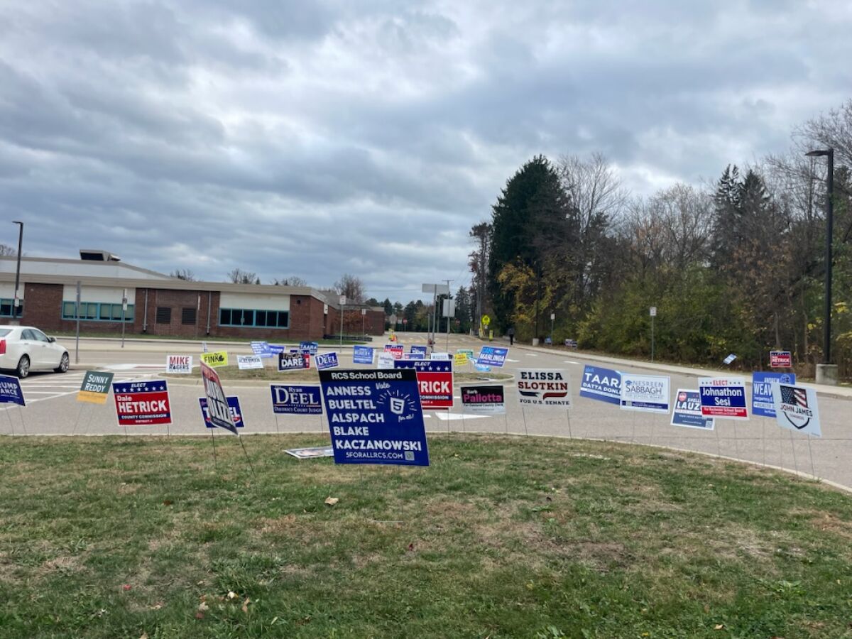  Political signs advertise candidates for office, including candidates for the Rochester Community Schools Board of Education. 