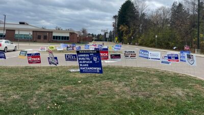  Political signs advertise candidates for office, including candidates for the Rochester Community Schools Board of Education. 